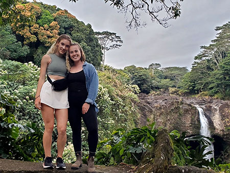 Study USA students posing in front of scenic water fall in Hawaii