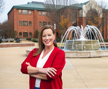 Student standing in front of fountain at Anderson Hall