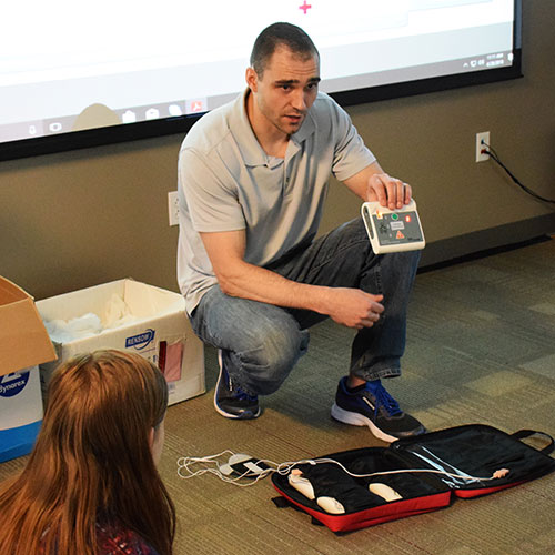 CPR class leader demonstrating equipment