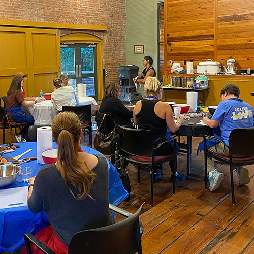Instructor and student making tamales in class