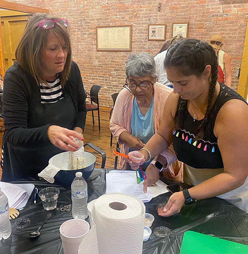 Instructor and student making tamales in class