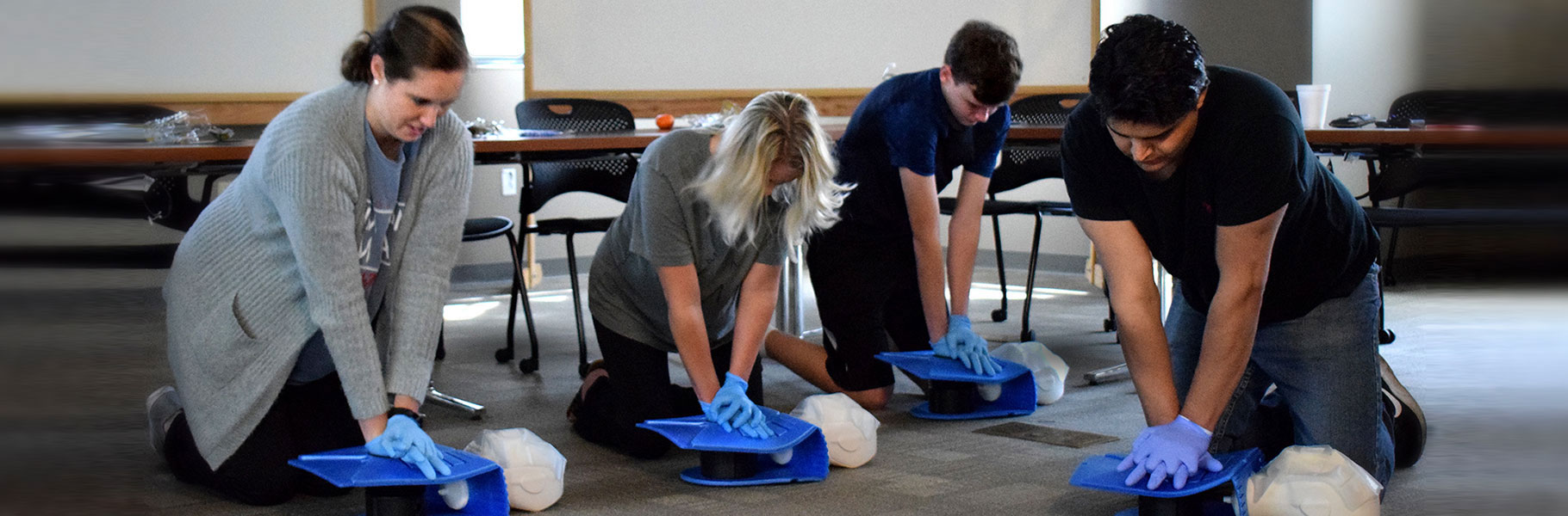 CPR class students practicing on dummies