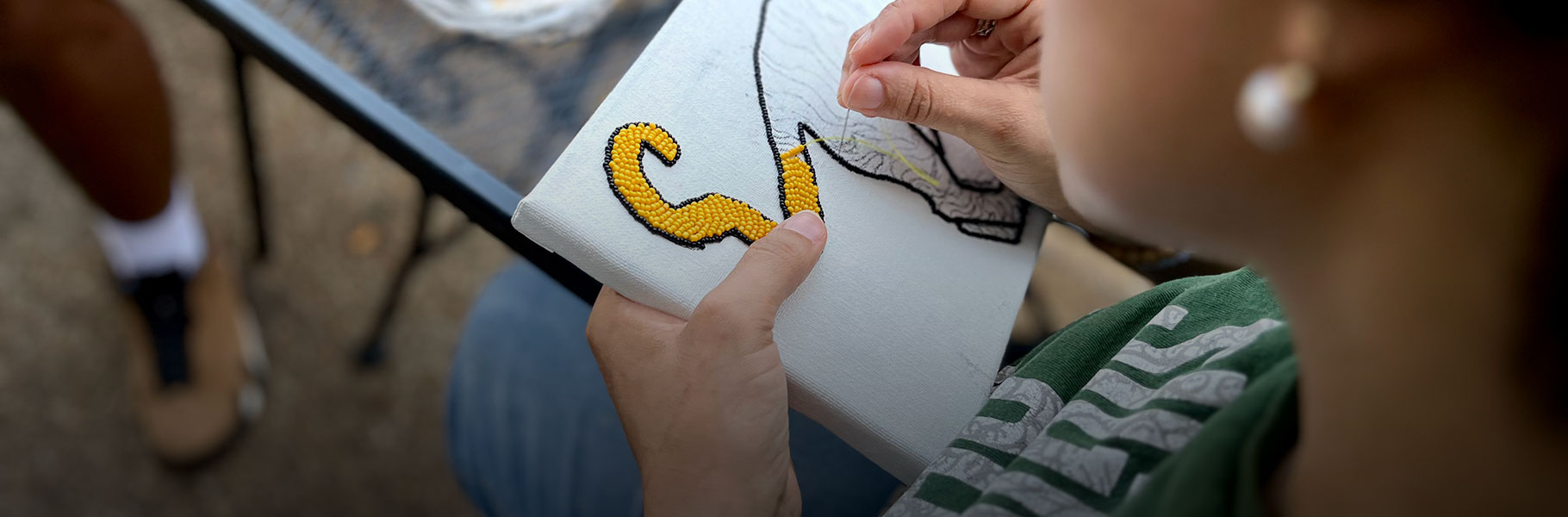 woman peading a tiger image on a small canvas
