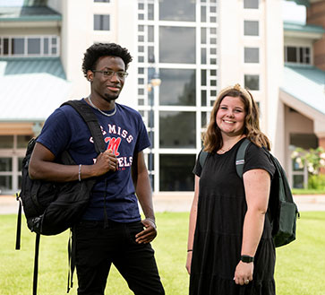 Student standing in front of fountain at Anderson Hall