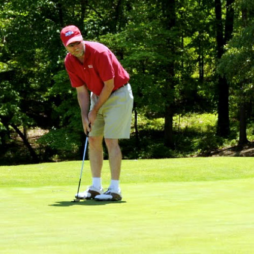 MBA Golf Classic golfer putting