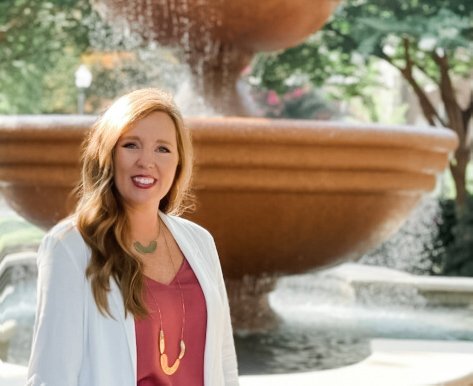 Katie Harrison in front of the fountain in the quad on the Ole Miss Campus