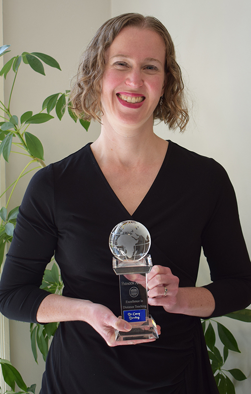 Carey Dowling holding award