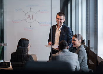 Group of marketing professionals in front of white board having meeting