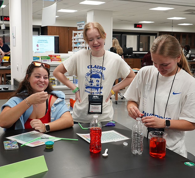 three students working on experiment