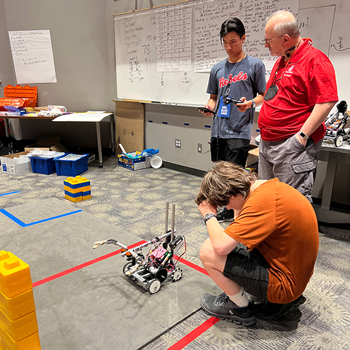 male student working on robotics project