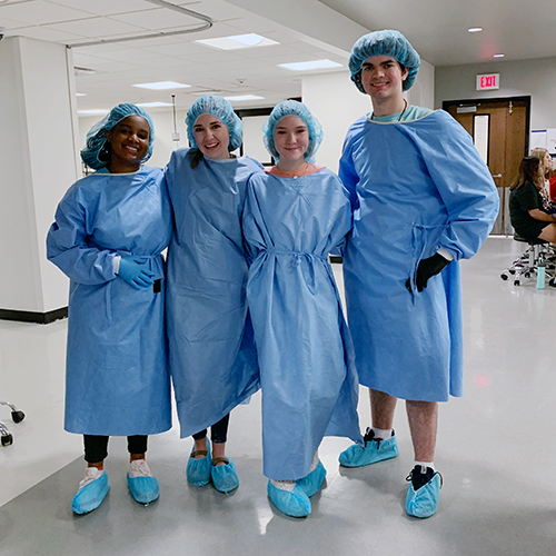 Pharmacy camp participants in scrubs