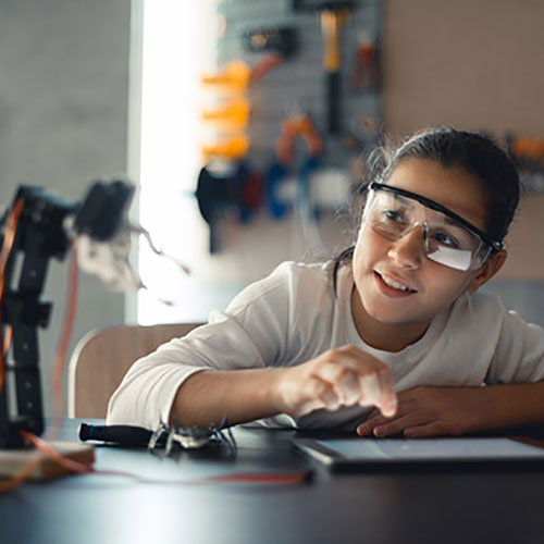 female student working on robotics project
