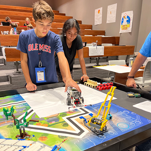 two students working on robotics project