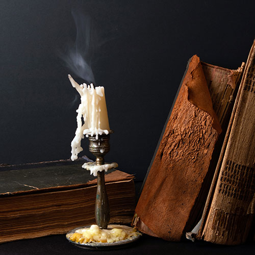 Candlestick and old books for gothic literature