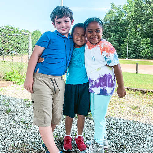 Three Rebel Quest Students playing outdoors