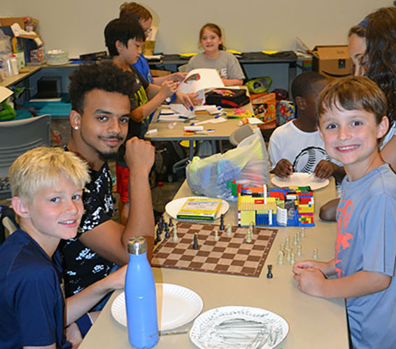 group of kids and a counselor at a lunch table
