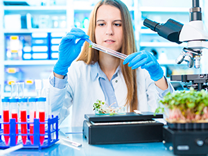 Female student working in a lab with test tubes