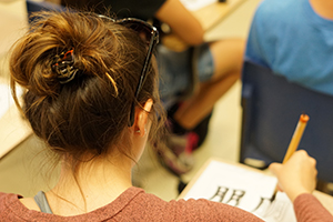 Student doing chinese brush characters