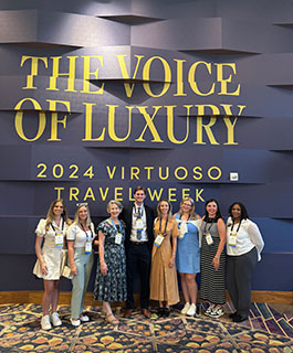 students posing in front of sign at 2024 conference
