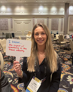 Student holding up sign that says I learned...