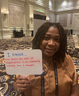 Student holding sign displaying what she learned