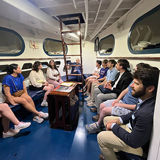 students at WW2 museum inside exhibit