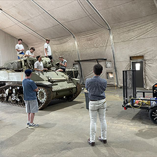 students looking at tank in WW2 museum