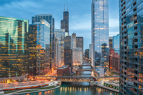 View of downtown Chicago at sunset with city lights shining