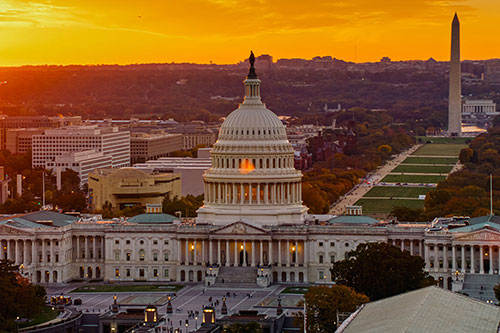 Helicopter shot of the United States Capitol Building in Washington, D.C. at sunset