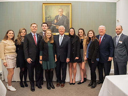 Students posing with representatives in Washington DC