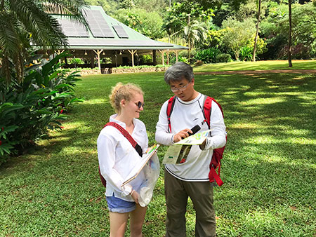 Student and professor going over notes doing field work in Hawaii