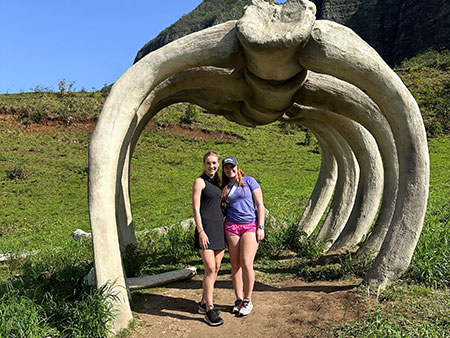 Students posing with dinosaur bones