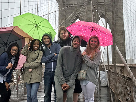 Students posing in front of Brooklyn bridge