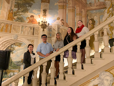Students on ornate staircase during study usa course