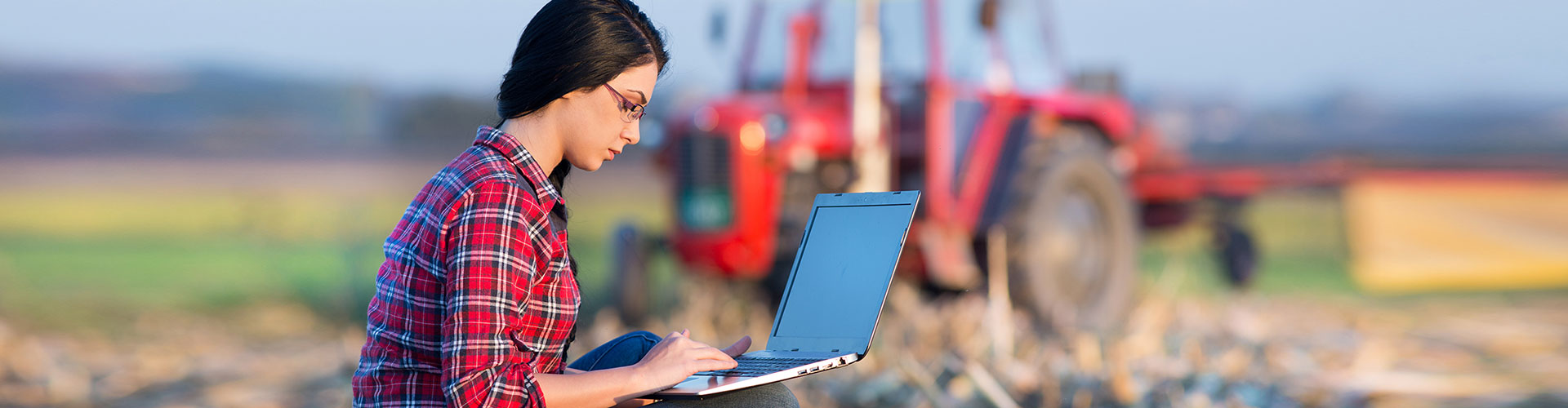 Woman with laptop in Mississippi Delta field