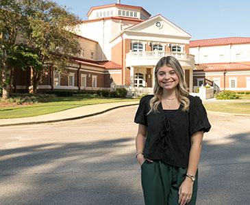Student standing in front of Tupelo Advanced Learning Center